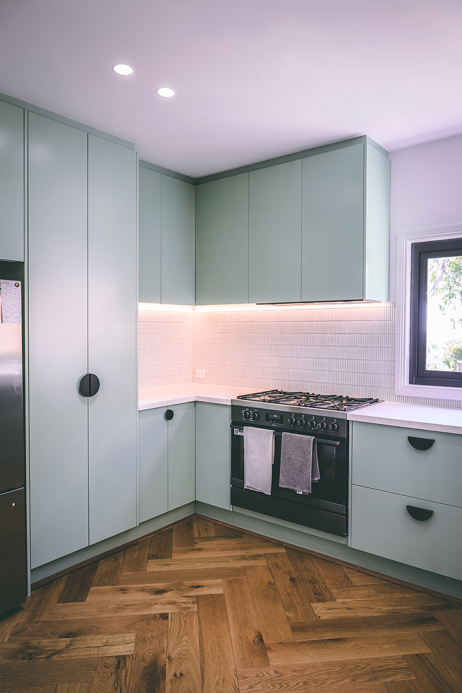 Kitchen tower and cabinets in mint and white colour